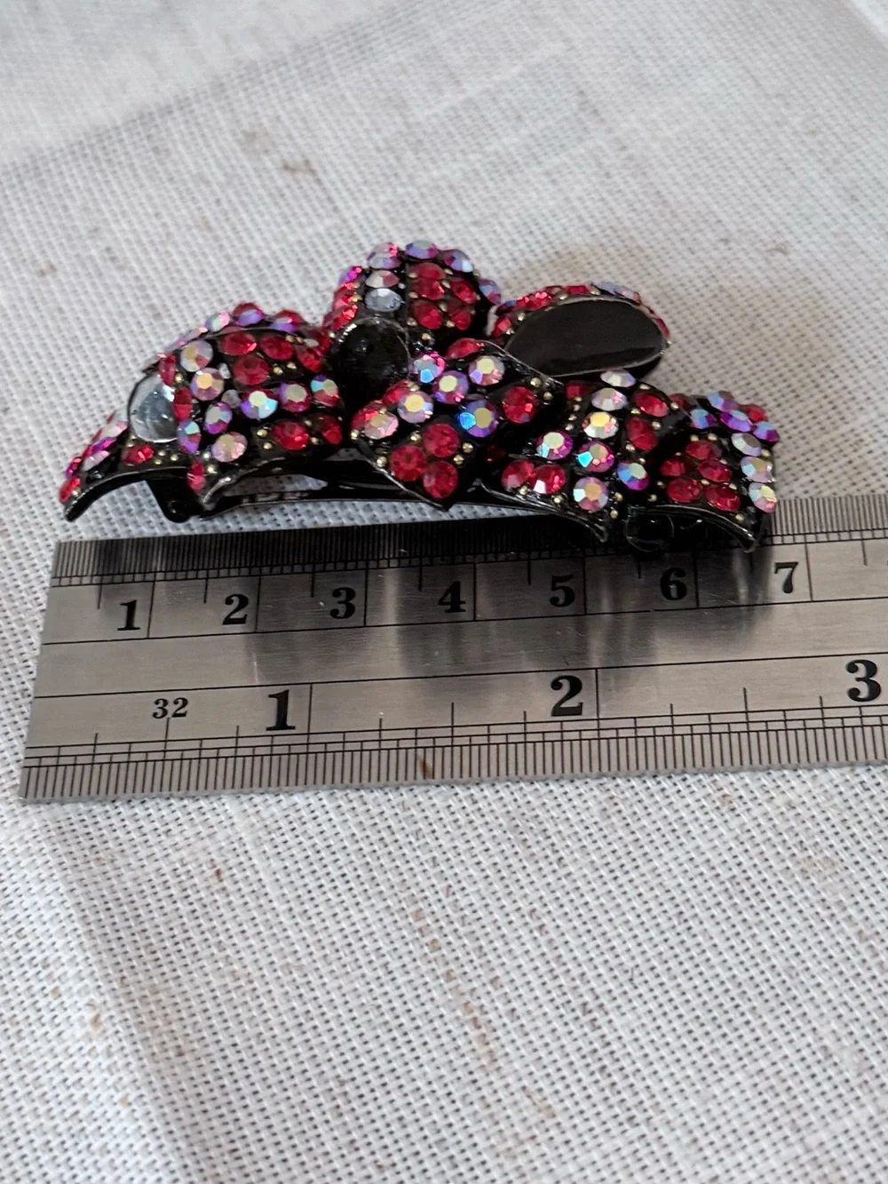 red rhinestone bow hair claw clip embellished with sparkling red and aurora bore